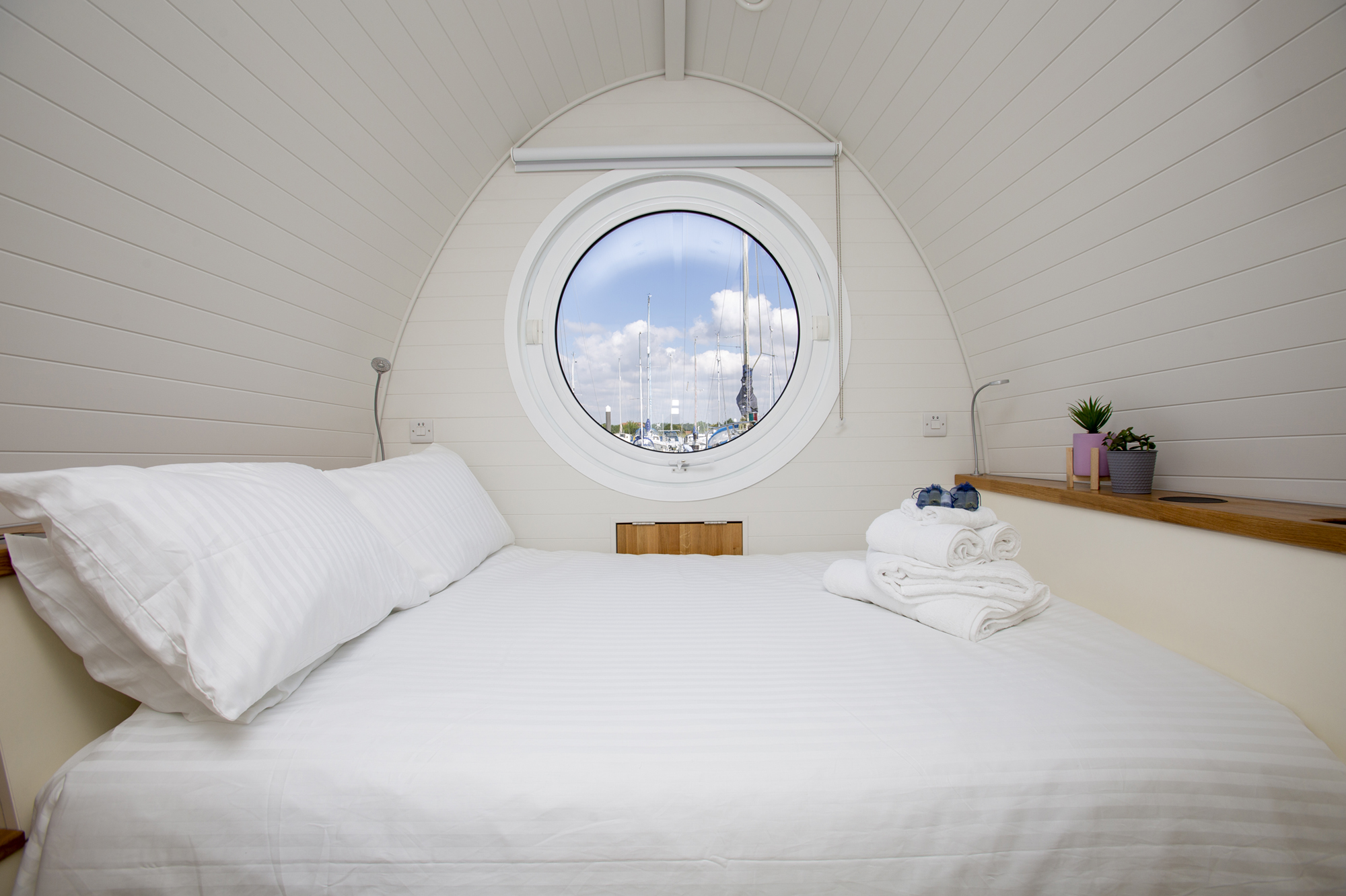 Comfortable double bed with porthole window